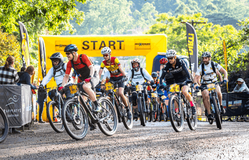 Riders preparing bikes together in the outdoors